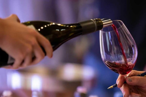 Bottle of wine being poured into a glass