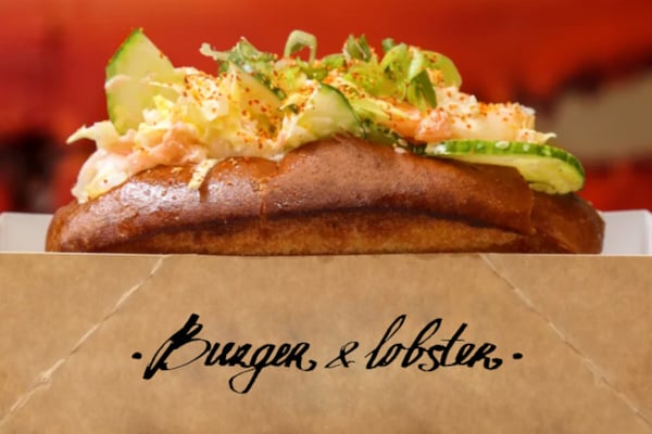 Burger and Lobster roll in a branded takeaway container