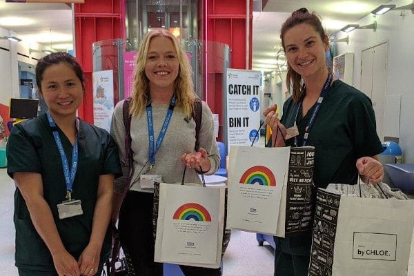 The NHS workers holding up bags of donated food
