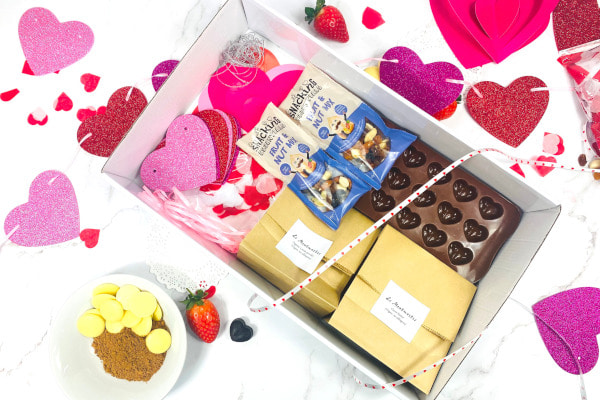 Box filled with ingredients and tools for creating valentines chocolates