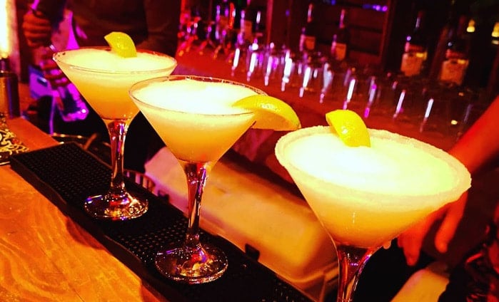 Three cocktails on a bar top
