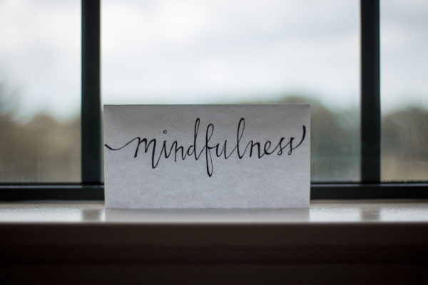 Piece of paper on a windowsill that reads Mindfulness