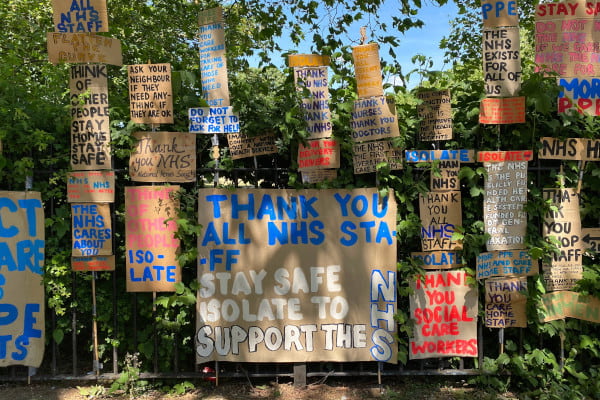 Cardboard signs with handwritten messages to the NHS