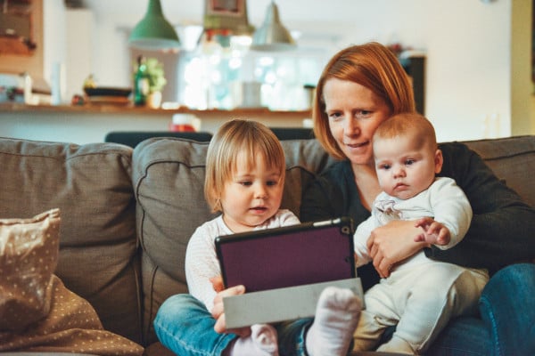 Woman with two young children on the sofa