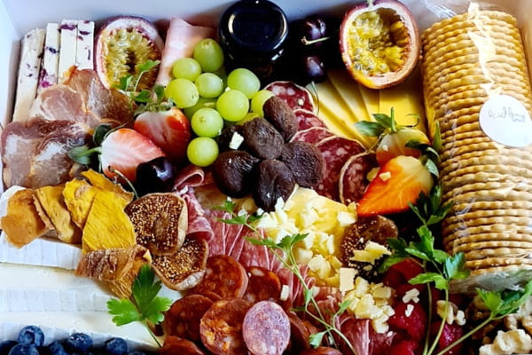 Cheese, crackers and fruits in a box