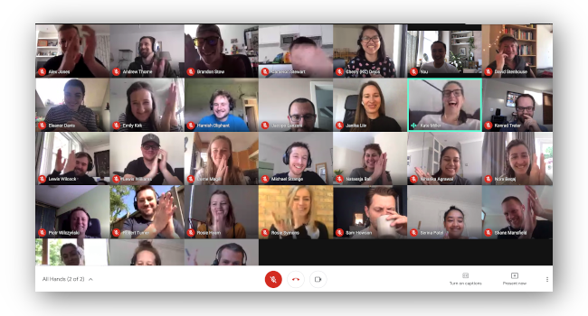 Company-wide video call, everyone is clapping on camera