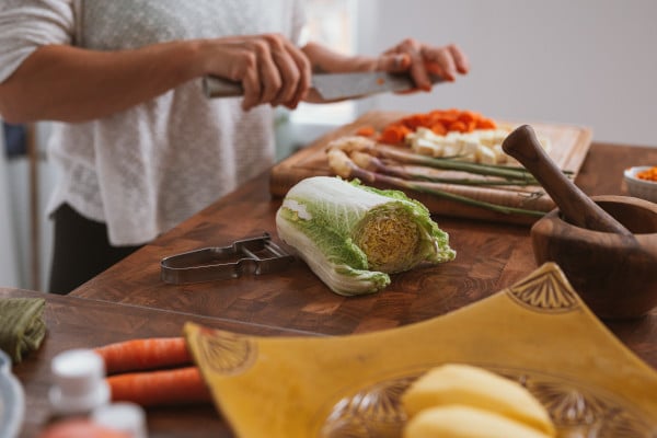 Someone chopping up veg on a chopping board