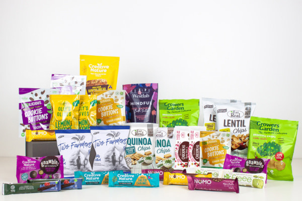 lots of snack bags and bars against a white background