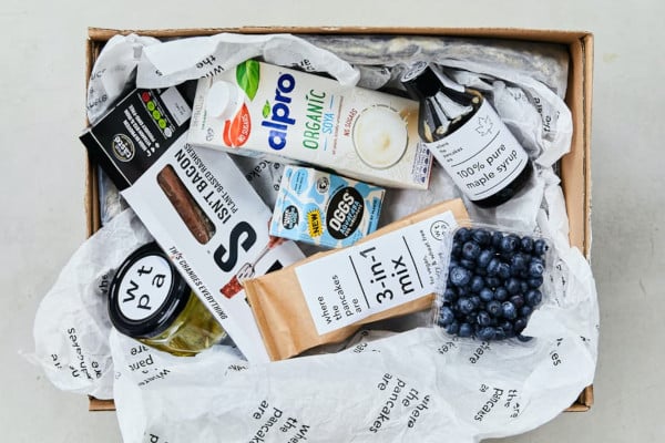 Box full of vegan pancake ingredients and toppings